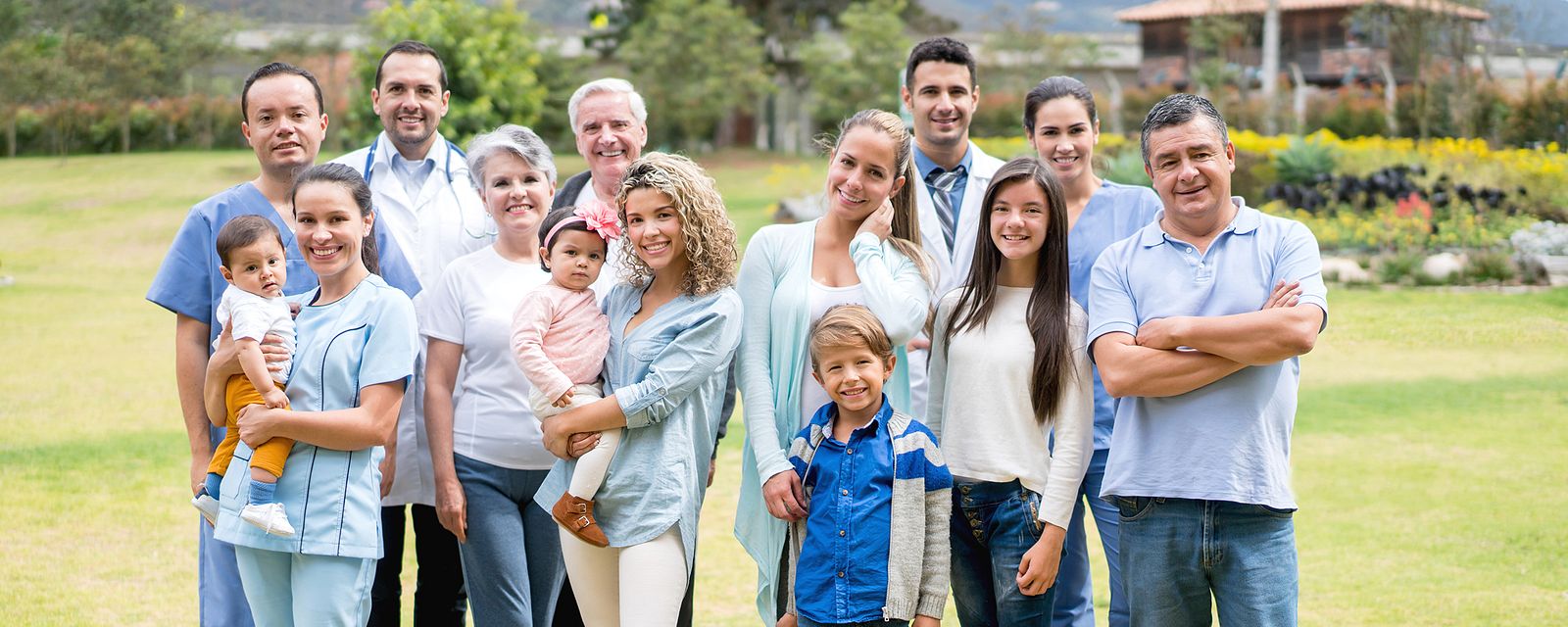 Family standing in grassy area outside hospital